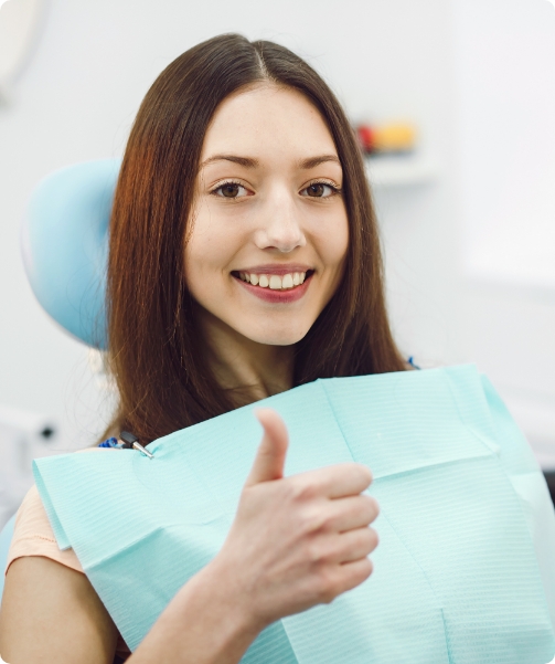Patient giving a thumbs up in the dental chair